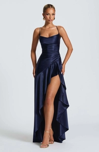 Navy blue evening gown with a high slit on a white background