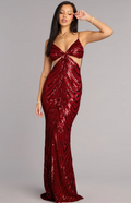 A woman modeling a floor-length, deep V-neck evening gown covered in shimmering red sequins, posed against a solid gray studio background.